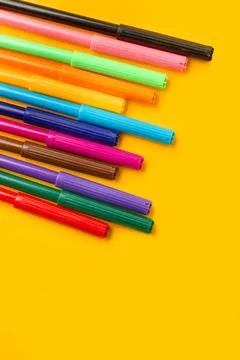 Colored markers on a yellow background with copy space Stock Photos