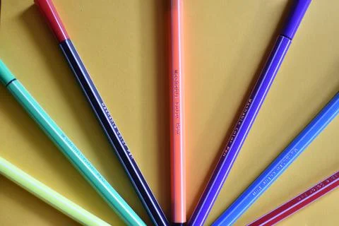 Colored markers on yellow background Foto stock