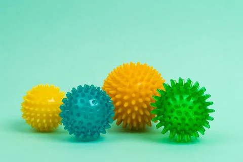 Colored massage needle balls of different sizes on a turquoise background, the Stock Photos