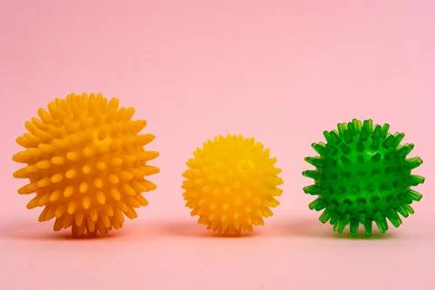 Colored massage needle balls of different sizes on a pink background, the Foto stock