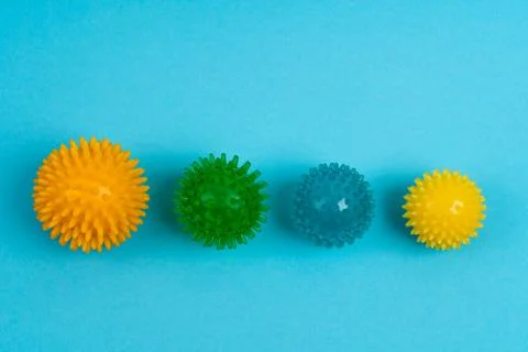 Colored massage needle balls of different sizes on a blue background, the Stock Photos