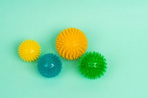 Colored massage needle balls of different sizes on a turquoise background, the Foto stock