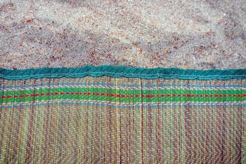 Colored Mat on the beach sand as a background Photos