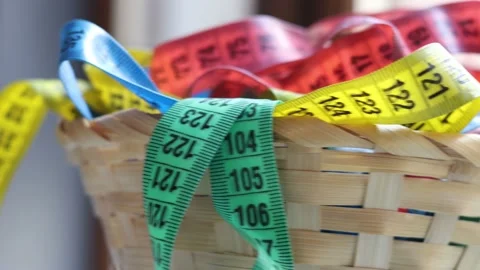 Colored measuring tapes in a wicker basket Stock Footage 172195884