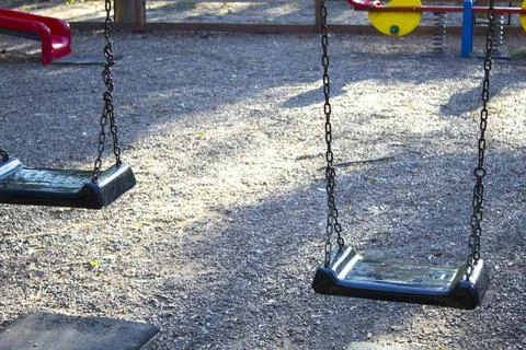 Colored metal children's playground in the autumn park Stock Photos