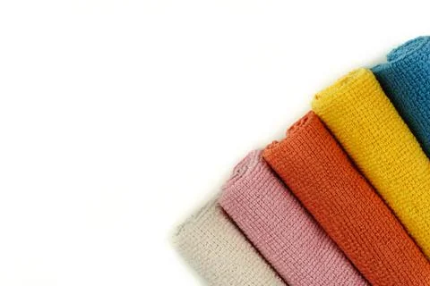 Colored microfiber cloths, lying in a row. Microfiber cleaning cloth. Isolated. Stock Photos