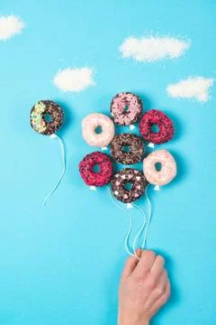 Colored mini donuts on blue background, creative food idea, donuts balloons Stock Photos