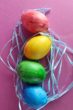 Colored multicolored painted Easter eggs background blue green yellow red on Stock Photos