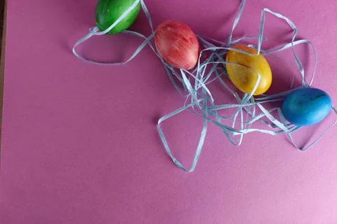 Colored multicolored painted Easter eggs background blue green yellow red on Stock Photos