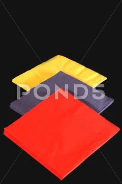 Colored napkins on black Stock Photos