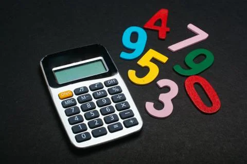 Colored numbers beside calclator  math skills concept Stock Photos