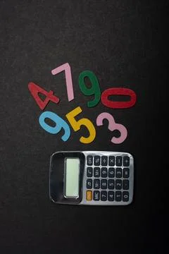 Colored numbers beside calclator  math skills concept Stock Photos