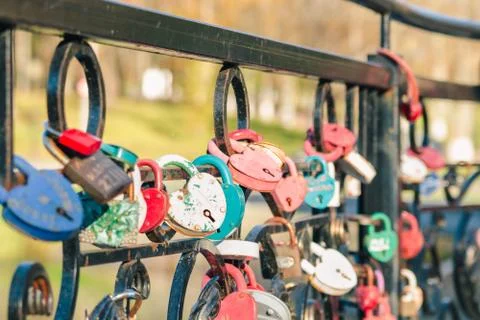 Colored old wedding locks in the shape of a heart hang Stock Photos