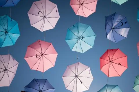 Colored open umbrellas on sky background. Stock Photos