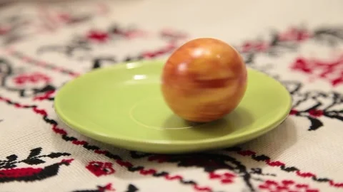 Colored orange egg for Easter is spinning Stock Footage 131146944