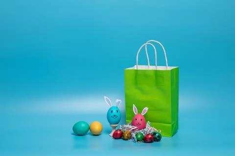 Colored package and easter eggs on a blue background Stock Photos