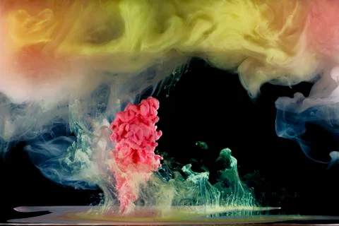 Colored paint mixed moving in fluid Stock Photos