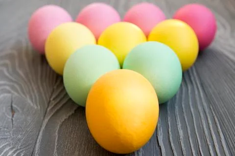 Colored painted eggs on a gray background. Easter celebrating Stock Photos