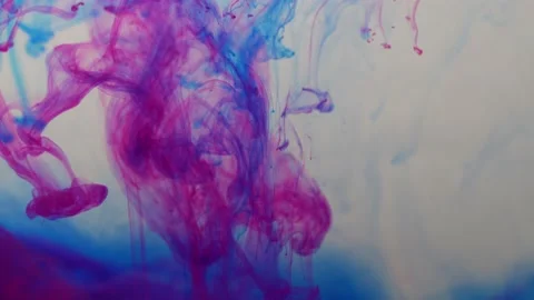 Colored paints are mixed in water. Bright abstract background. Stock Footage 224021442