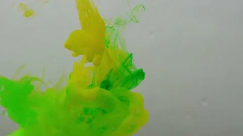 Colored paints are mixed in water. Bright abstract background. Stock Footage 224021886