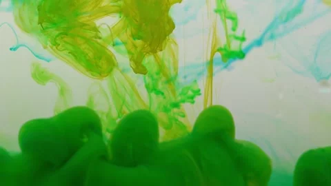 Colored paints are mixed in water. Bright abstract background. Stock Footage 224441130