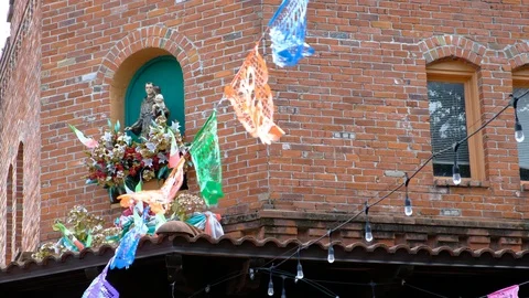 Colored papel picado hanfing on string at historic Market Place Video stock 109080694