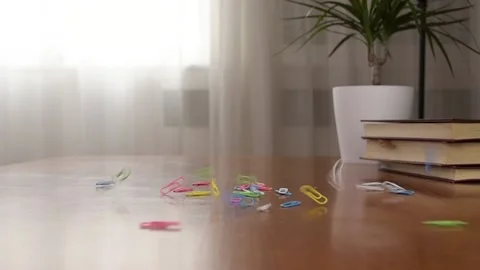 Colored Paper Clips Falls On The Table. Slow Motion Video. Video stock 150278958