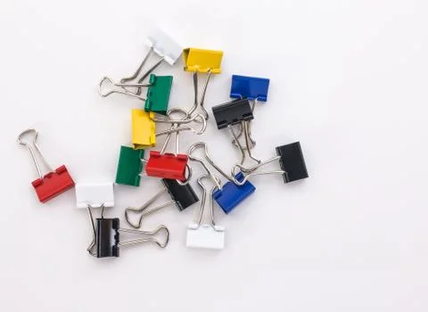 Colored paper clips on a white background Stock Photos