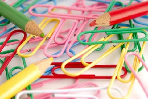 Colored paper clips on white Stock Photos