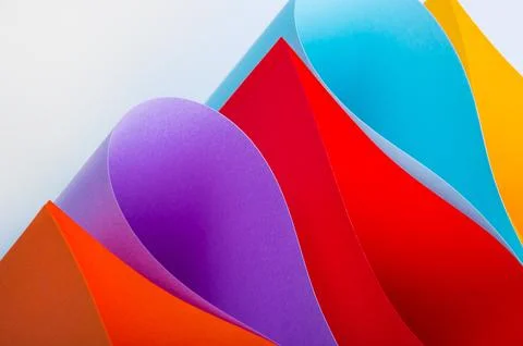 Colored paper on gray background Stock Photos