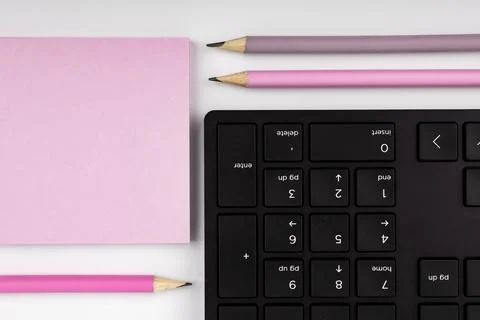 Colored paper with important message lying desk near keyboard. Main information Stock Photos