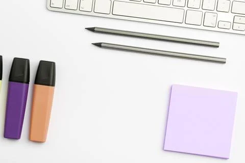 Colored paper with important message lying desk near keyboard. Main information Stock Photos