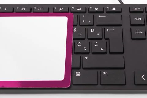 Colored paper with important message lying desk near keyboard. Main information Stock Photos