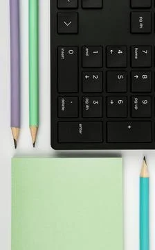 Colored paper with important message lying desk near keyboard. Main information Stock Photos