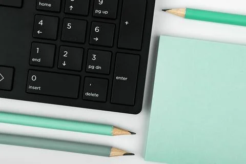 Colored paper with important message lying desk near keyboard. Main information Stock Photos