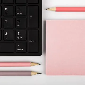 Colored paper with important message lying desk near keyboard. Main information Stock Photos