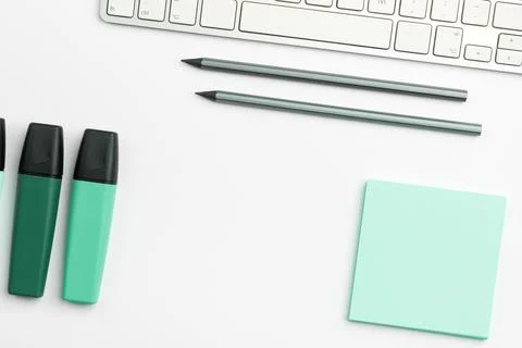 Colored paper with important message lying desk near keyboard. Main information Stock Photos