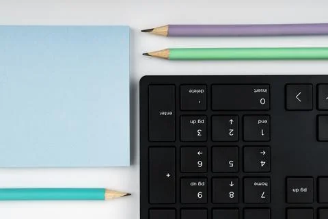 Colored paper with important message lying desk near keyboard. Main information Stock Photos