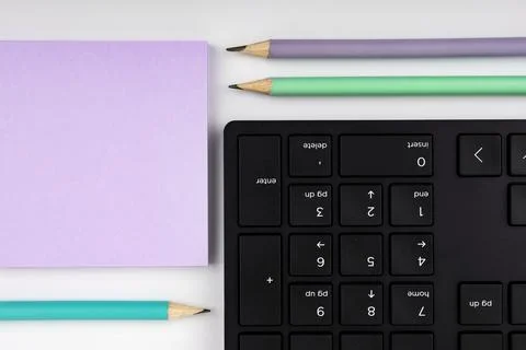 Colored paper with important message lying desk near keyboard. Main information Stock Photos