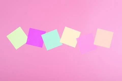 Colored paper on red background Stock Photos