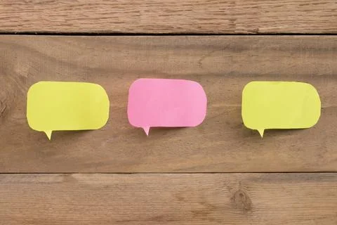 Colored paper reminder notes on a board or wooden background Stock Photos