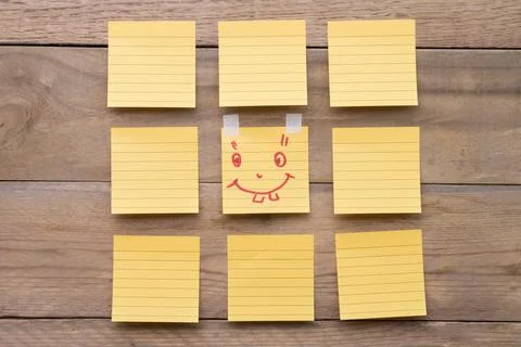 Colored paper reminder notes on a board or wooden background Stock Photos