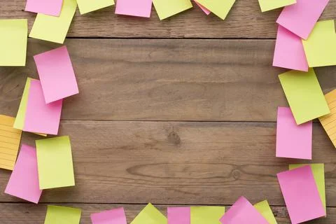 Colored paper reminder notes on a board or wooden background Stock Photos