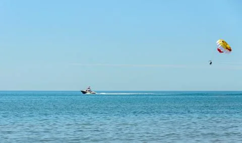 Colored parasail wing pulled by a boat in the sea water, Parasailing also kno Stock Photos