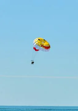 Colored parasail wing pulled by a boat in the sea water, Parasailing also kno Stock Photos