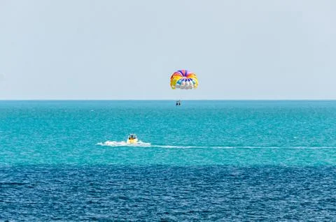 Colored parasail wing pulled by a boat in the sea water, Parasailing also kno Foto stock