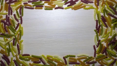 Colored pasta is collected in a frame. Background from colored pasta. 스톡 동영상 150236462