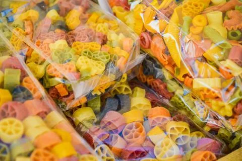 Colored pasta in transparent packages Stock Photos