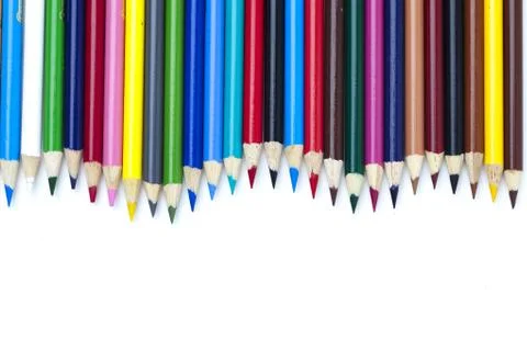 Colored pencil arranged side by side over white Stock Photos
