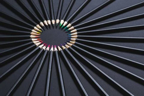 Colored pencil set arranged in circle on black background. Stationery back... Foto stock